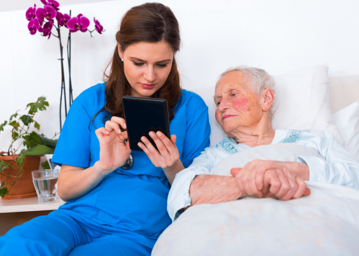 nurse-typing-notes-into-meetcaregivers-family-care-portal-on-her-tablet