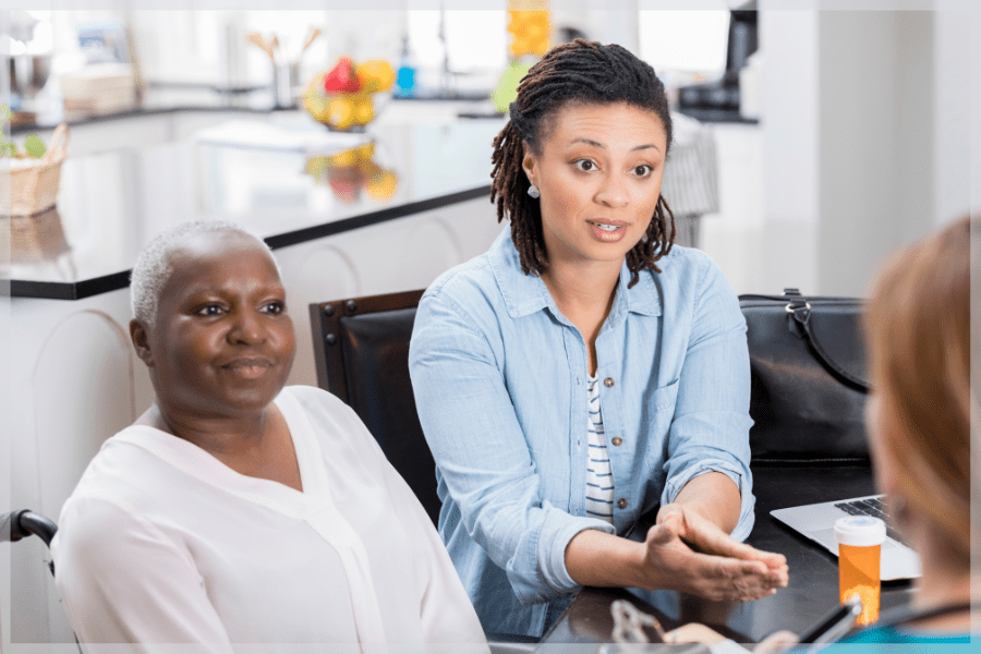 Adult daughter and her aging mother talking to a professional about respite care for caregivers - MeetCaregivers