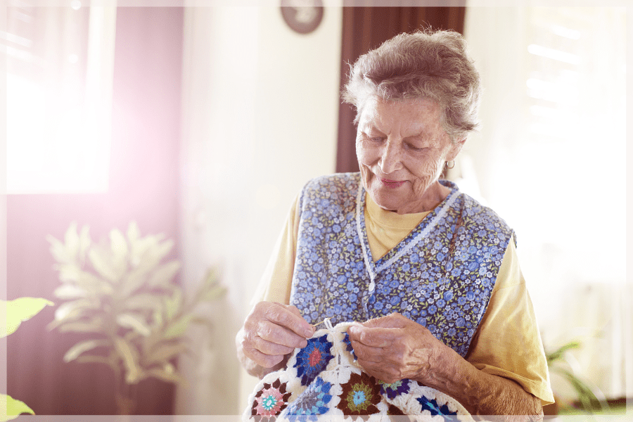 Jobs for seniors - Elderly woman crocheting a blanket - MeetCaregivers