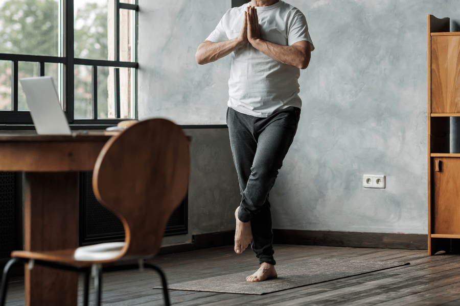 Senior Man Standing In Leg Yoga Balance As One Type Of Indoor Exercises For Seniors