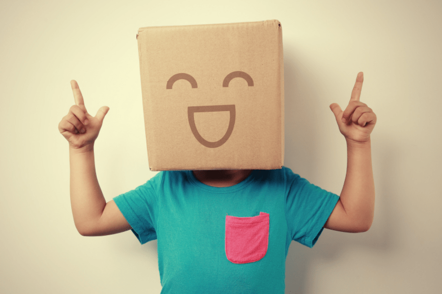 Toddler with a box on its head MeetCaregivers