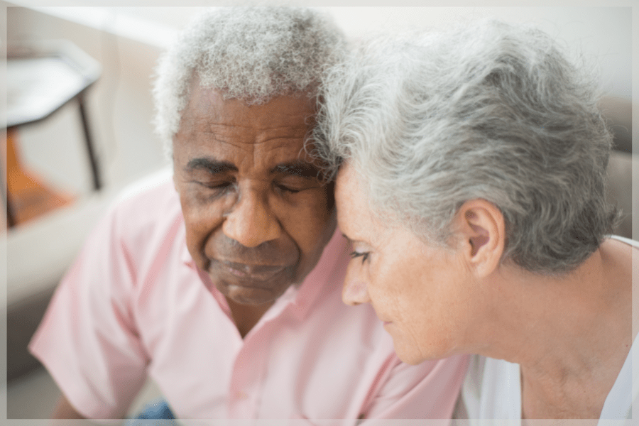 Depression in the elderly Senior woman comforting her sad husband MeetCaregivers