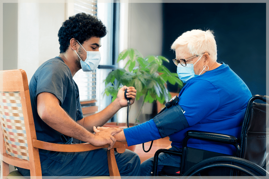 Benefits of being a CNA - Young CNA taking elderly woman's blood pressure - MeetCaregivers