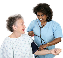 Certified Nursing Assistant - CNA Testing Vitals On Elderly Patient