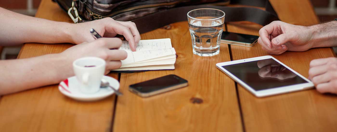 Caregiver - Someone Taking Notes On A Table And Phones