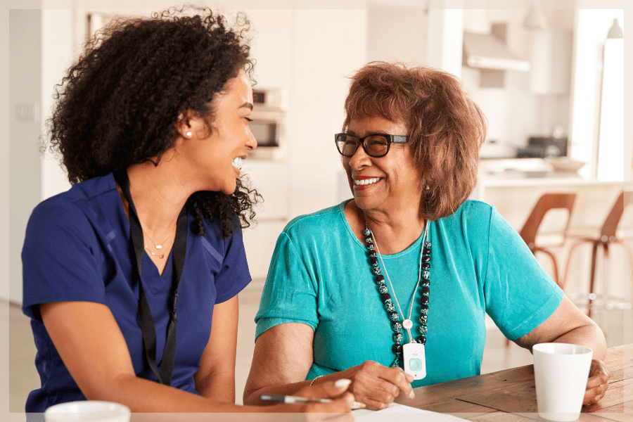 Caregiver communication - Young caregiver laughing with her senior client - MeetCaregivers