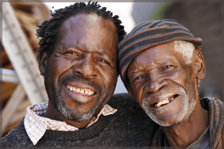 Self-Directed - Older man and his elderly father smiling together - MeetCaregivers