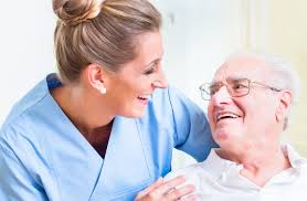 Caregiver - A Nurse Laughing With An Elderly Man