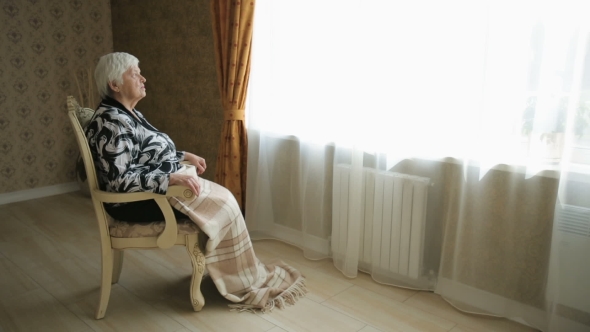 Senior Social Isolation - Elderly Woman Alone In A Chair
