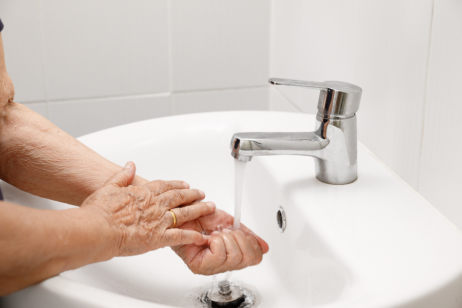 Aging in place remodeling - Elderly person washing their hands - MeetCaregivers