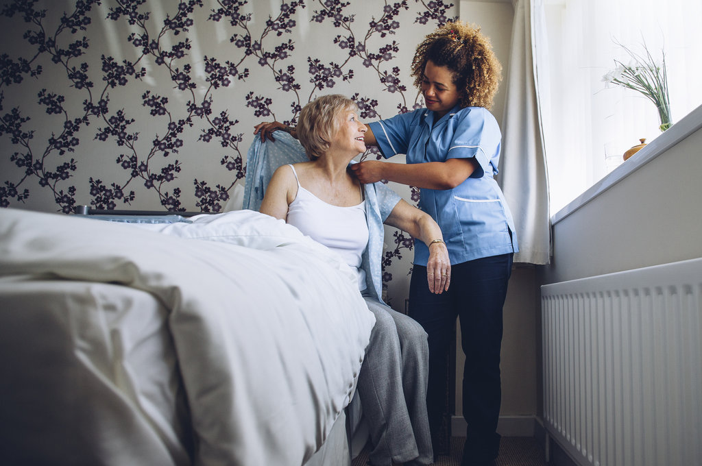 Respite Care - A Caregiver Helping Dress A Senior