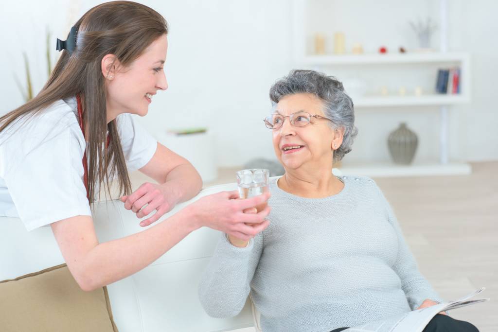 Respite Care - Caregiver Holding Elderly Woman's Hand