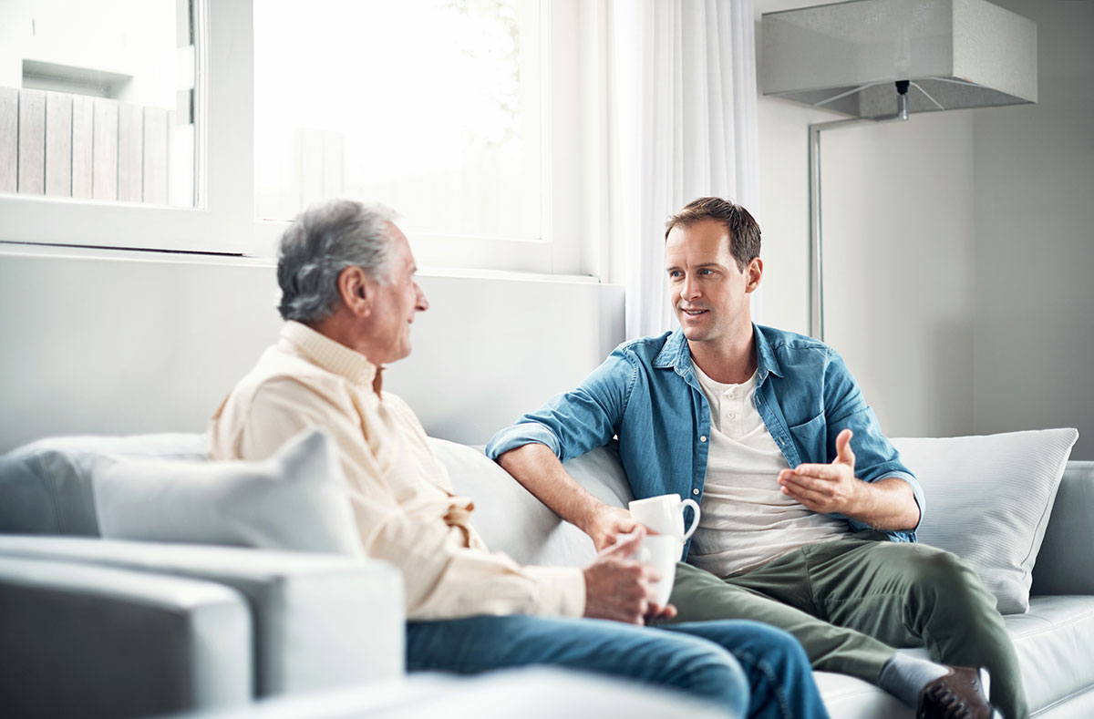 Respite Care - Middled Aged Son Talking To Senior Parent