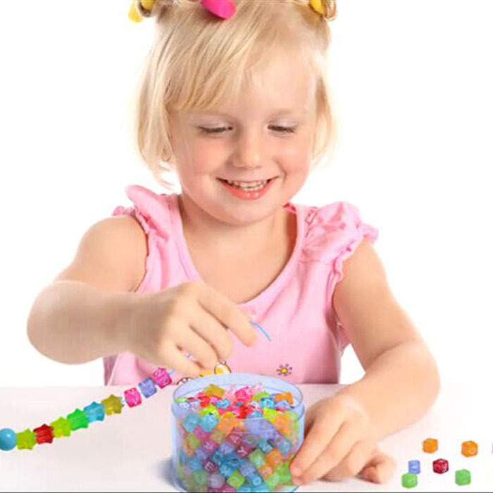 Summer Activities To Do With The Grandkids - A Child Making Bead Jewelry
