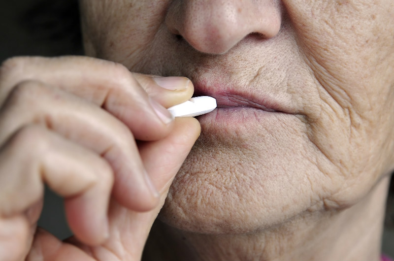 Sleep For Seniors - Elderly Person Taking A Pill