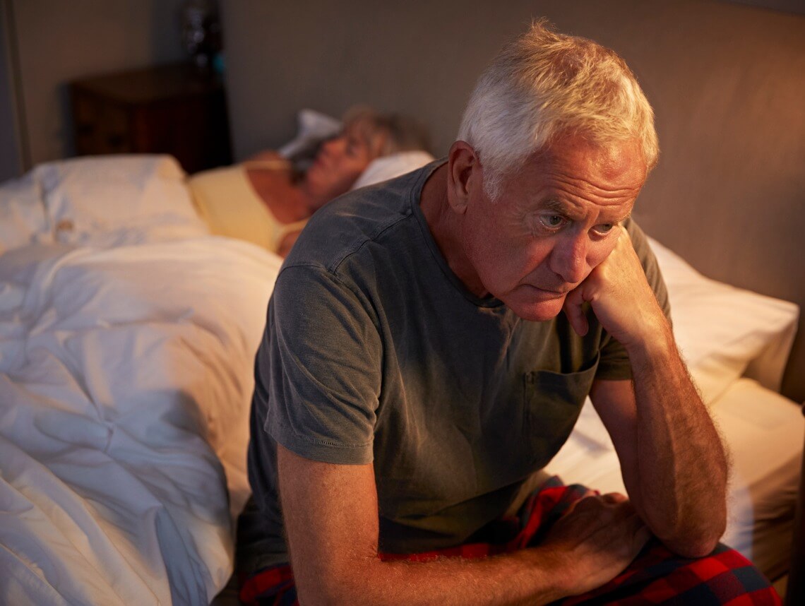 Sleep For Seniors - Senior Man Sitting On Edge Of Bed