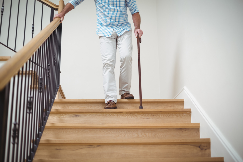 Summer Safety for Seniors - Elderly Man Walking Downstairs With A Cane