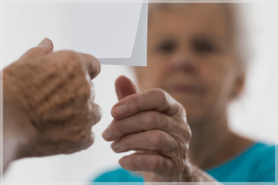 Alzheimers Awareness Month Elderly Woman Reaching For Sticky Note On Mirror MeetCaregivers