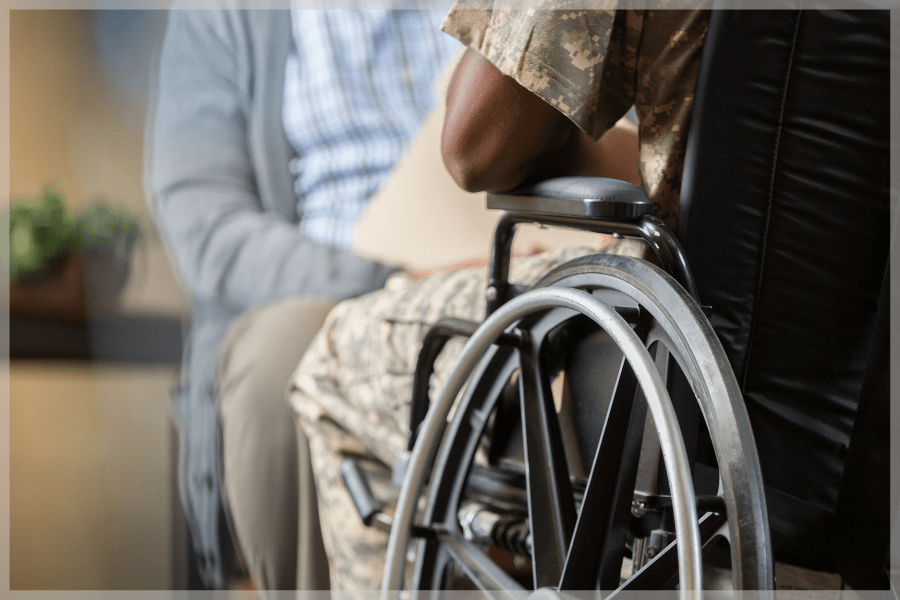 Elderly veterans - Wheelchair-bound veteran speaking to therapist - MeetCaregivers