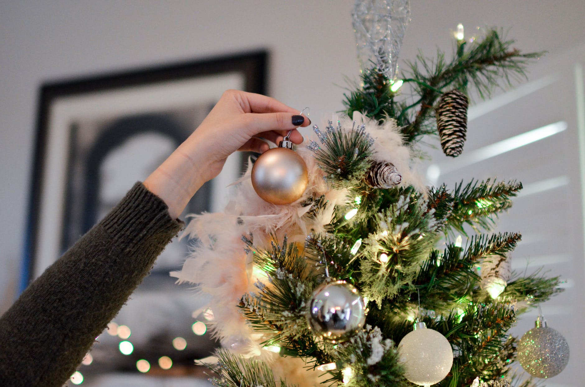 Senior Safety - A Woman's Hand Placing An Ornament On A Tree