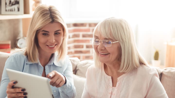 Winter Nutrition For Seniors - A Woman And Her Mother Looking At An iPad