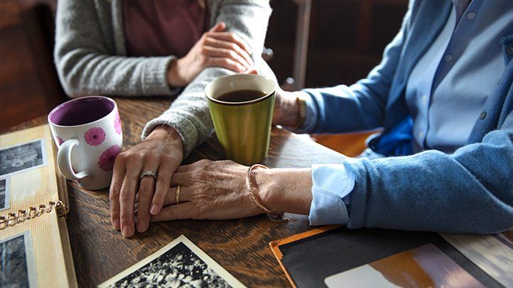 How To Talk To Your Parents' Doctor - Two People Holding Hands At A Table