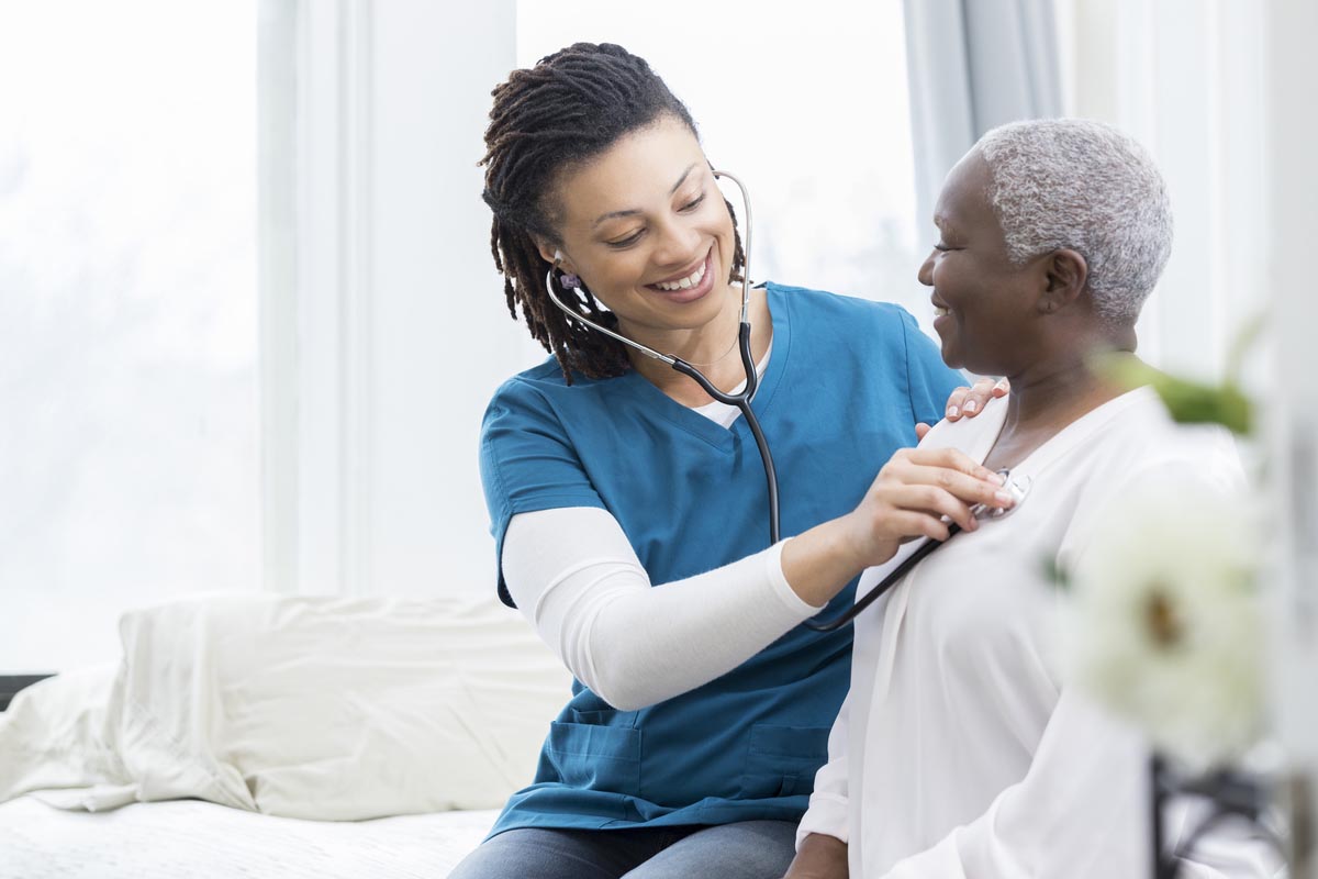 Senior Health Care - A Nurse Checking An Elderly Woman's Heart