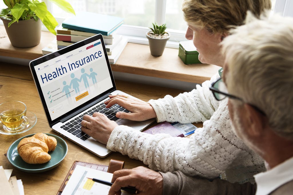 Senior Health Care - A Senior Couple Picking Insurance Plance