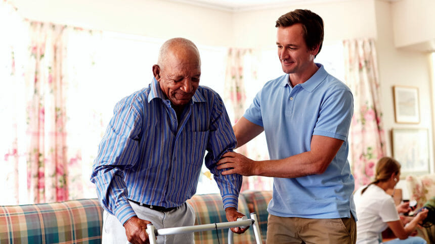 Benefits Of Caregiving - Caregiver Assiting Elderly Man With A Walker