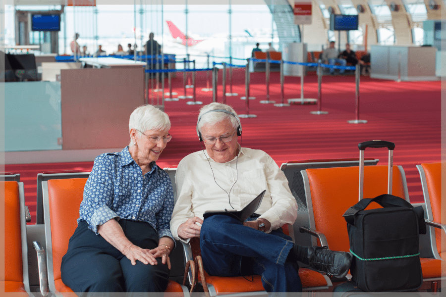 Travel tips for seniors - Elderly couple sitting at the airport - MeetCaregivers
