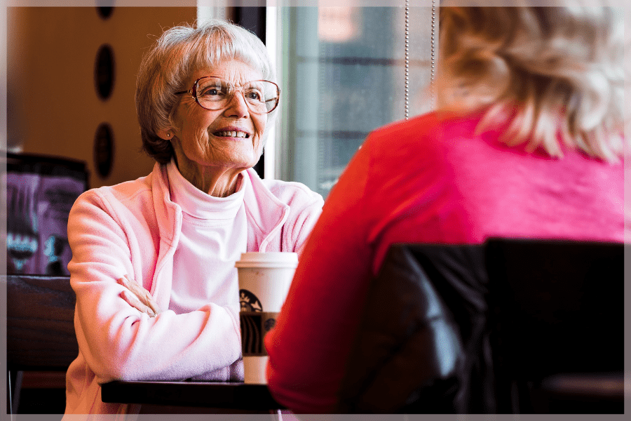 Travel tips for seniors - Senior mother and mature daughter at cafe - MeetCaregivers