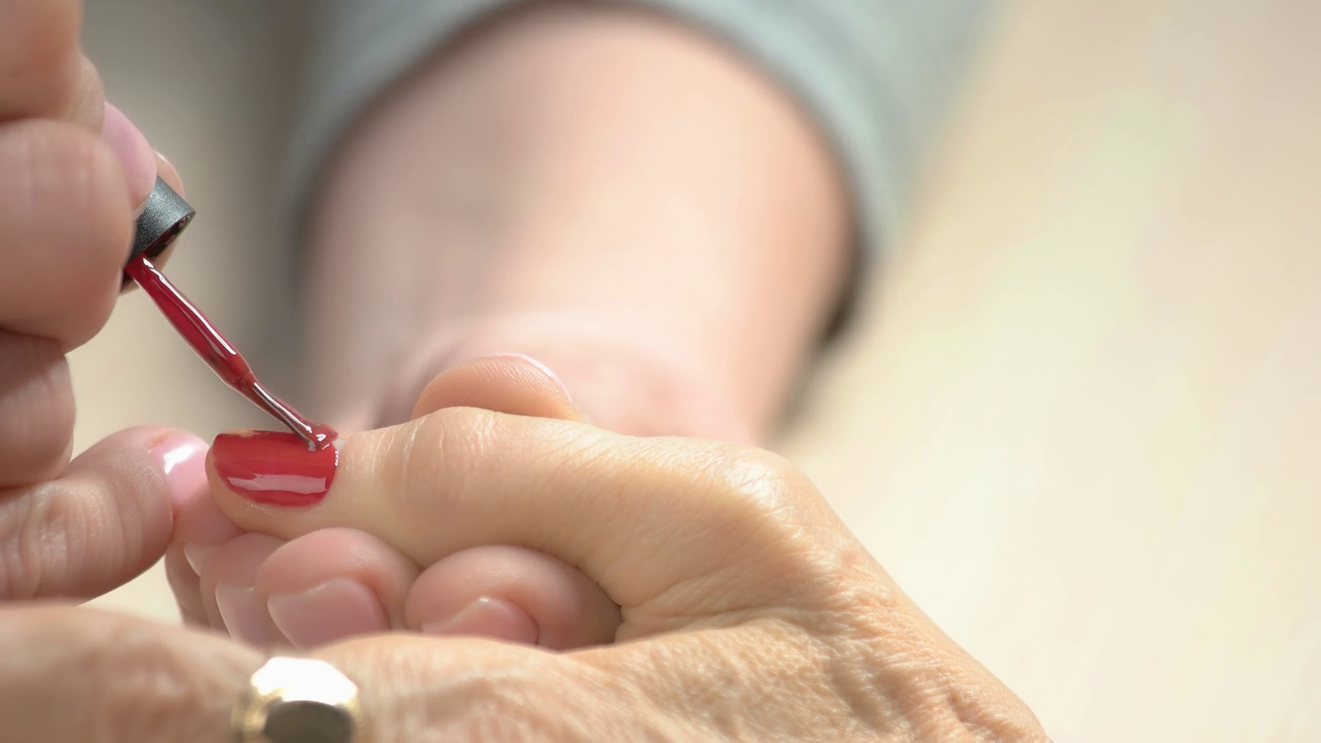 Activities For Seniors - Nail beautician painting nails to old woman in beauty salon close up.