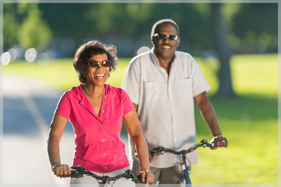 American Heart Month - Smiling senior couple riding bikes together - MeetCaregivers