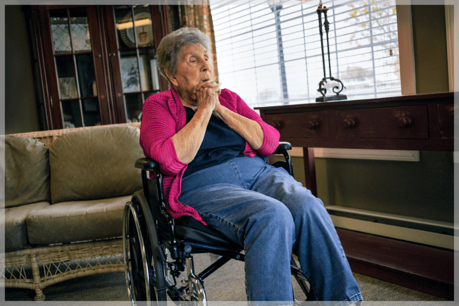 Elder Abuse Elderly woman sitting in a wheelchair beside her living room window MeetCaregivers