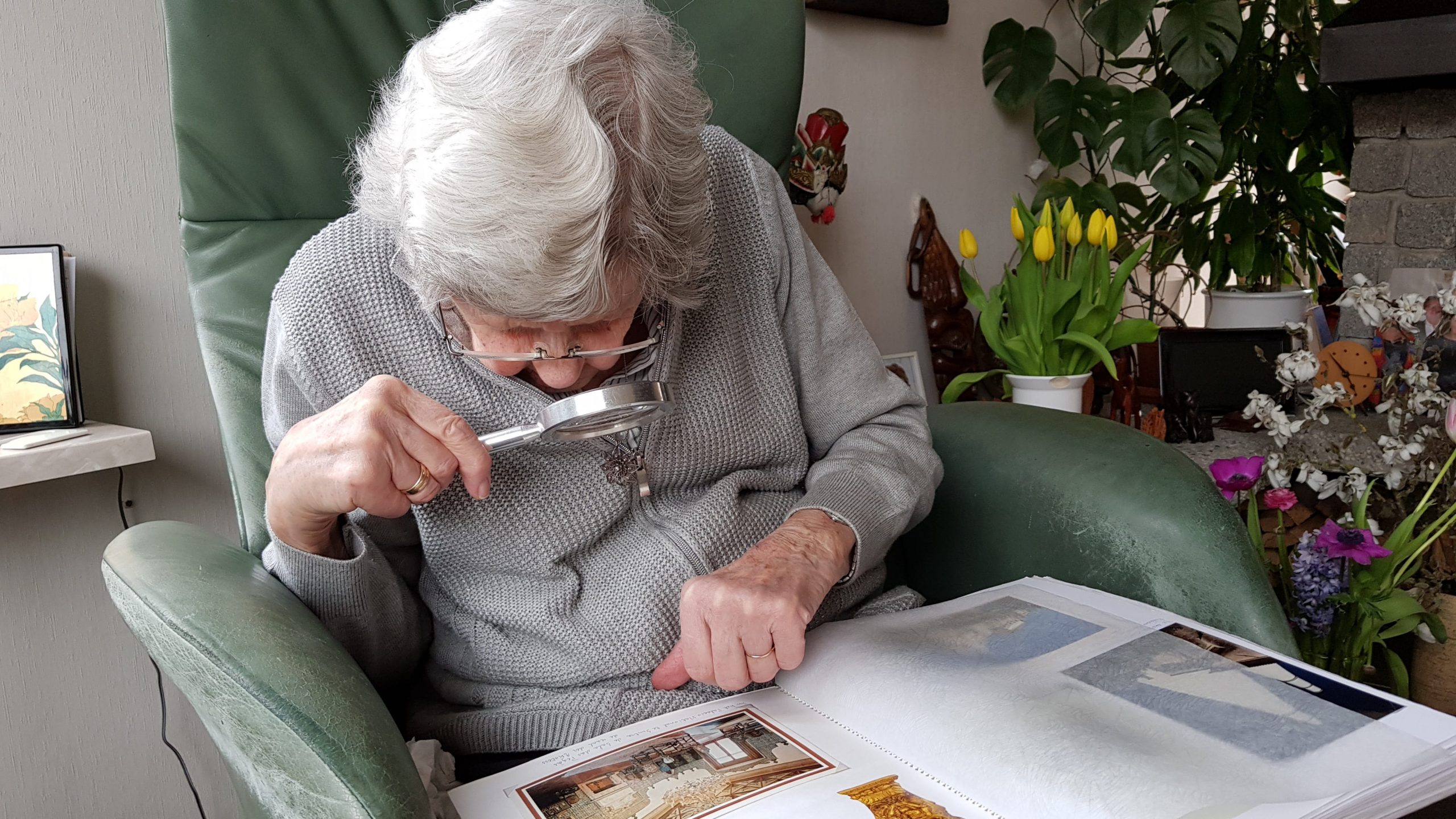 Eye-Health-Woman-In-Gray-Coat-Reading-Book-With-Magnifying-Glass