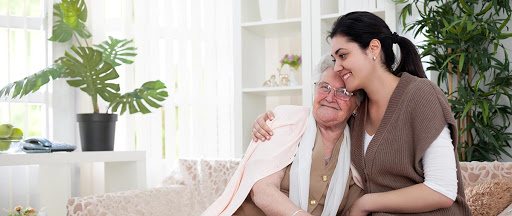 elder-care-options-a-young-woman-embracing-an-elderly-woman-in-the-living-room