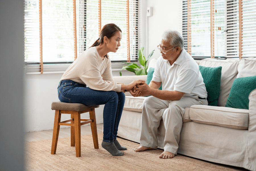 Elderly Man Speaking To His Grandaughter During National Mental Health Month