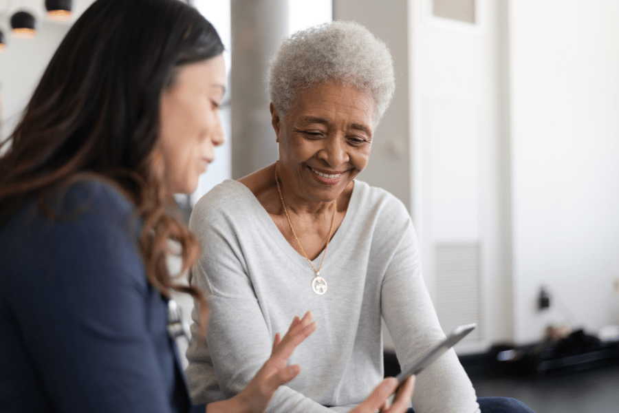 Senior Woman Talking To Her Doctor About Osteoporosis