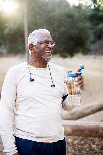 A-senior-African-American-Man-enjoying-refreshing-water-after-a-workout