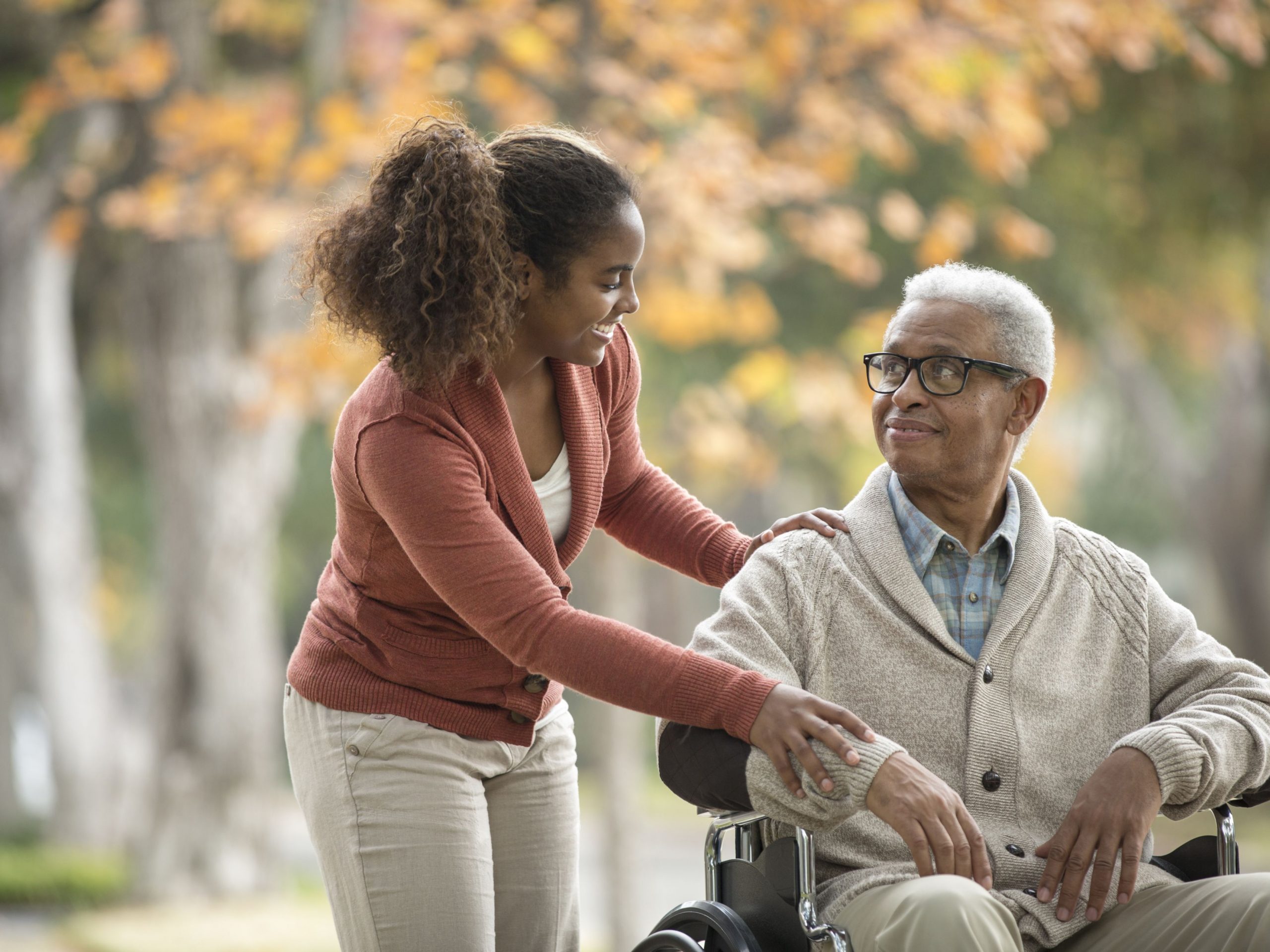 work-life-balance-young-woman-pushing-older-man-in-wheelchair