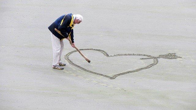 Senior Dating - Old Man Drawing A Heart In The Sand