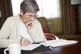 Home Care Services - A Senior Looking At Paperwork