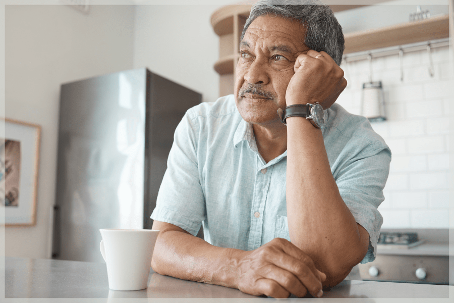 Benefits of home care - Pensive senior man drinking coffee in his kitchen - MeetCaregivers