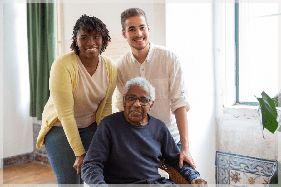 Healthy Aging Month Elderly man sitting with his granddaughter and caregiver MeetCaregivers