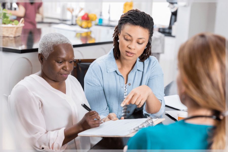 Paid caregiver - Adult daughter helping elderly mother with medical paperwork - MeetCaregivers