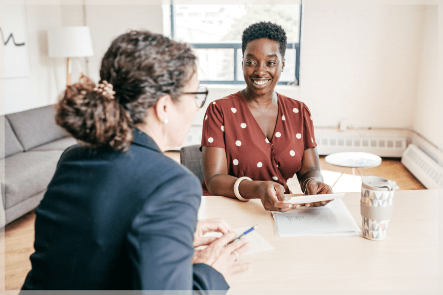 Resources for family caregivers - Two women talking in an office - MeetCaregivers