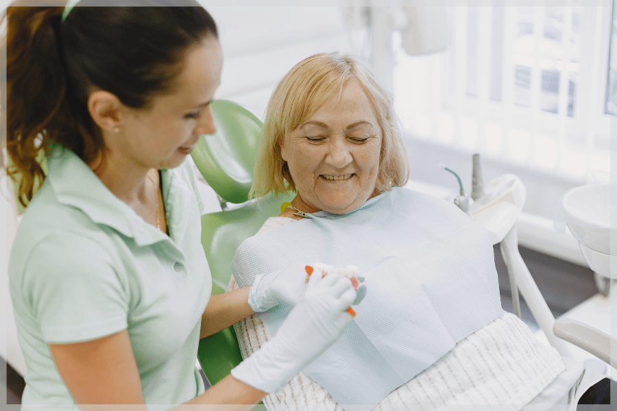 National Dental Hygiene Month - Senior woman getting her teeth cleaned at the dentist - MeetCaregivers