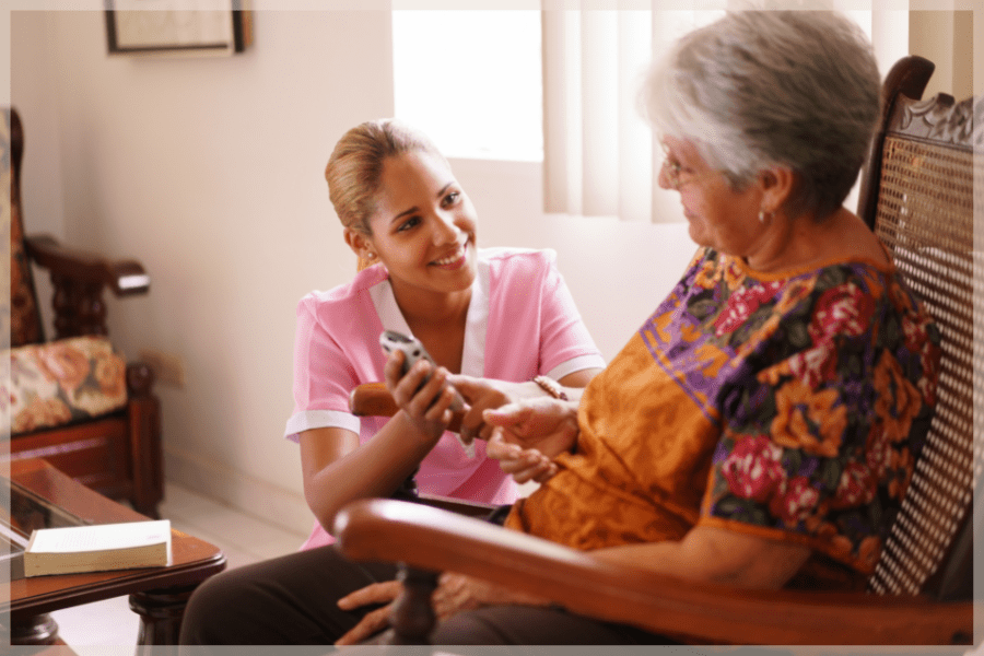 Palliative Care At Home - Caregiver comforting elderly woman in her rocker - MeetCaregivers