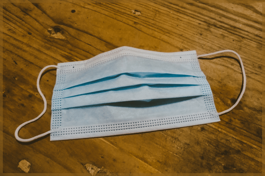 Types of face masks One surgical mask laying on a wood table MeetCaregivers