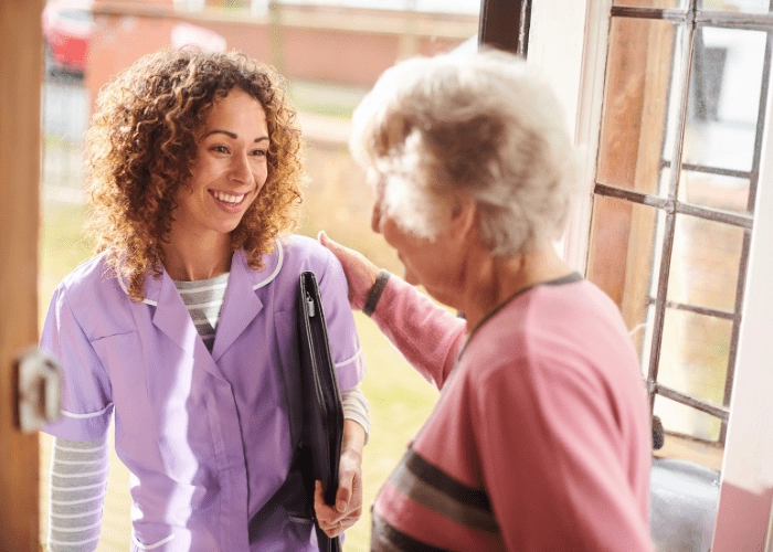 Caregiver Certification - Elderly woman welcoming her caregiver into her home. - MeetCaregivers